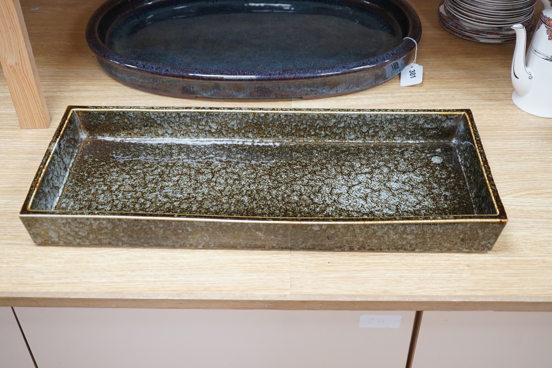 A large Japanese studio pottery oval dish and a larger studio pottery rectangular dish, largest 60cms wide x 24.5cms deep